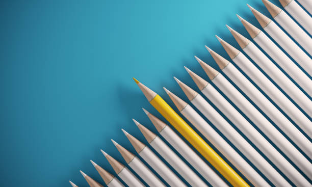 Orange Colored Pencil Standing Out From The Crowd