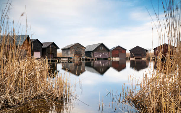 Neusiedlersee Boathouses between Water and Reeds Lake Neusiedl boathouses between water and reeds kanal stock pictures, royalty-free photos & images