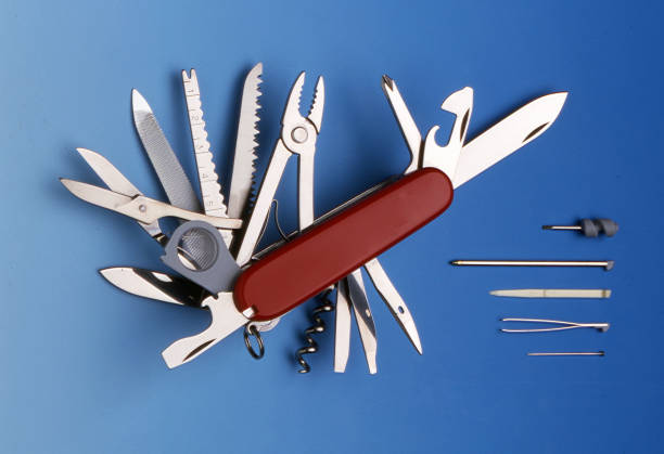 Swiss universal knife with its tools Photo taken in studio, in France, on a blue background with artificial lights penknife stock pictures, royalty-free photos & images