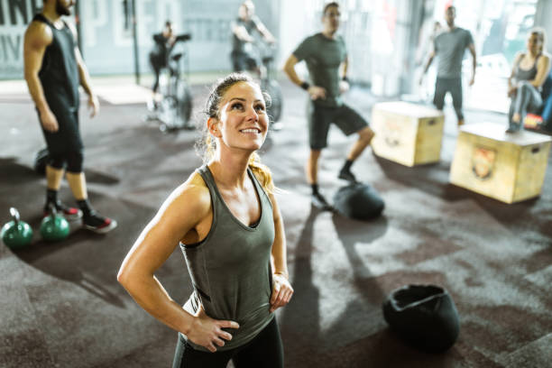 istock Happy athletic woman taking a break from cross training in a gym. 1136799138