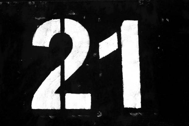 istock Number 21 in stencil on metal wall in black and white. 1136799597