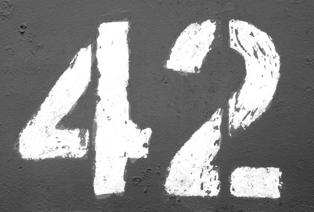 Number 42 in stencil on rusty metal wall in black and white Number 42 in stencil on rusty metal wall in black and white. Abstract background and texture for design. number 42 stock pictures, royalty-free photos & images