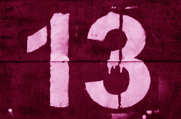 istock Number 13 in stencil on metal wall in pink tone. 1136800824