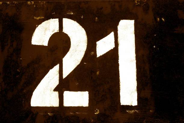 istock Number 21 in stencil on metal wall in brown tone. 1136800940