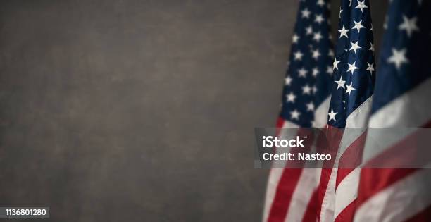 American Flags Over Gray Wal With Copy Space Stock Photo - Download Image Now - American Flag, USA, Veteran