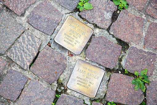 Aschaffenburg / Germany - June 2018. Stolperstein or stumbling stone by Gunter Demnig in Aschaffenburg. Two cobblestones remembering the victims of the deportation and killing by the Nazis during the second world war.