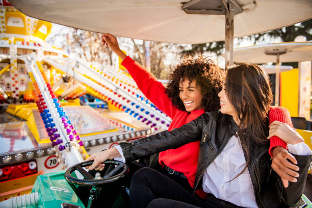 istock Two friends riding amusement park ride 1136804506