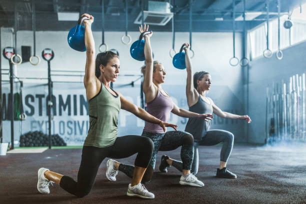 istock Young female athletes exercising with kettle bells on gym training. 1136805193