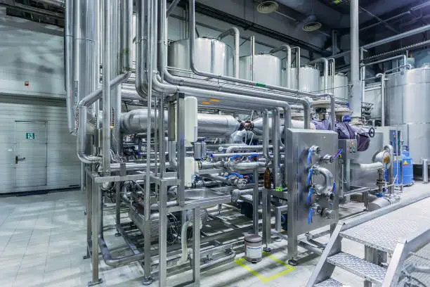 Photo of Modern brewery interior. Equipment of beer production line