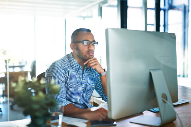 He's a diligent worker Cropped shot of a handsome young businessman working in his office image focus technique stock pictures, royalty-free photos & images