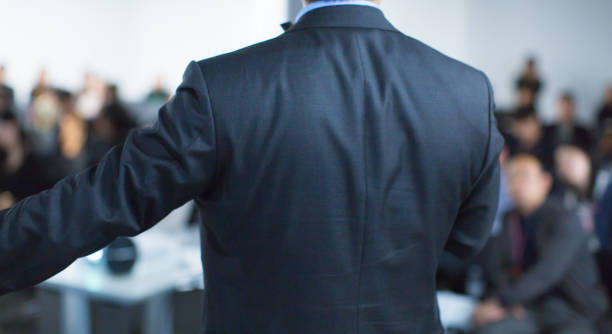 istock Speaker at Talk in Business Conference. Executive Speaker Entrepreneur on Stage Conference Photo. Business Presentation Presenter Speech at Tech Meeting. Corporate Forum Event for Investor Audience. 1136808908