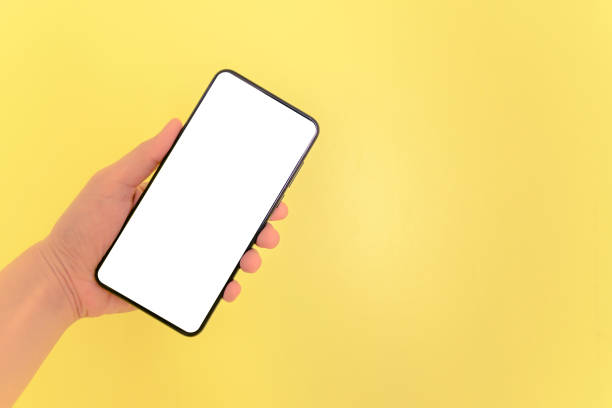 istock Human hand holding smartphone with white screen background. 1136808997