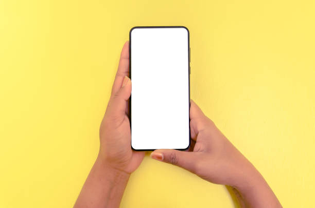 istock Human hand holding smartphone with white screen background. 1136809140