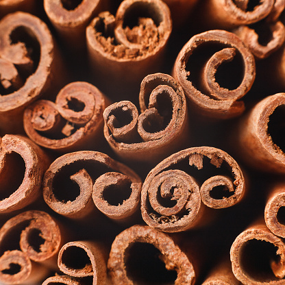 Cinnamon swirls texture background, closeup, top view