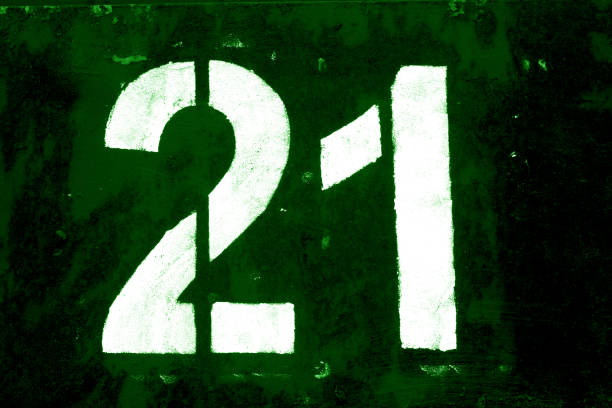 istock Number 21 in stencil on metal wall in green tone. 1136809650