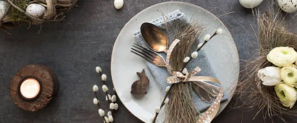 Photo of Easter place setting on dark table plate