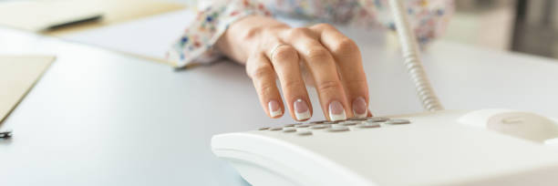 istock Wide view image of a secretary dialing telephone number 1136811237