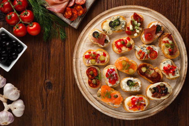 istock Crostini with different toppings on wooden background. 1136812879