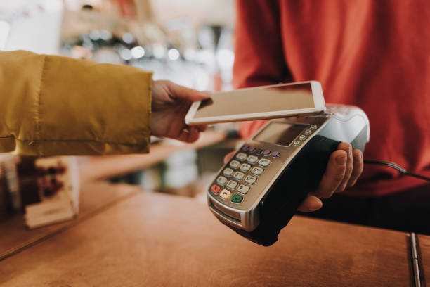 istock Young lady pay bill via contactless payments 1136813831