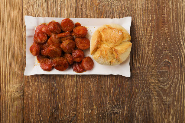istock Traditional German currywurst, served on disposable paper tray with a fresh bun. 1136813955