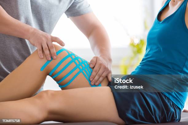Kinesio Taping On Womans Knee Stock Photo - Download Image Now - Doctor's Office, Physical Therapy, Health Club