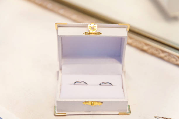 istock Two beautiful wedding rings on white jewelry box on light background 1136816188