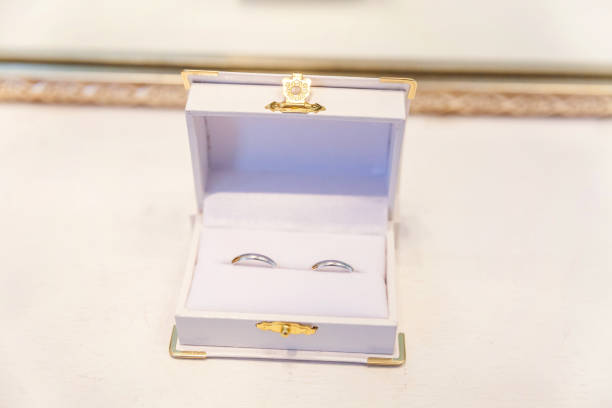 istock Two beautiful wedding rings on white jewelry box on light background 1136816214