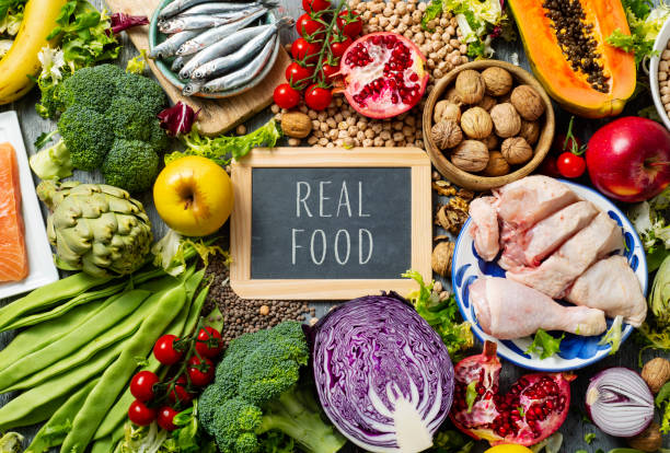 istock fruits, vegetables, fish, meat and text real food 1136816225