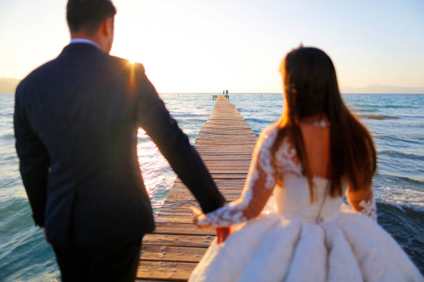 istock Wedding couple, bride, groom walking and posing on dock 1136816940