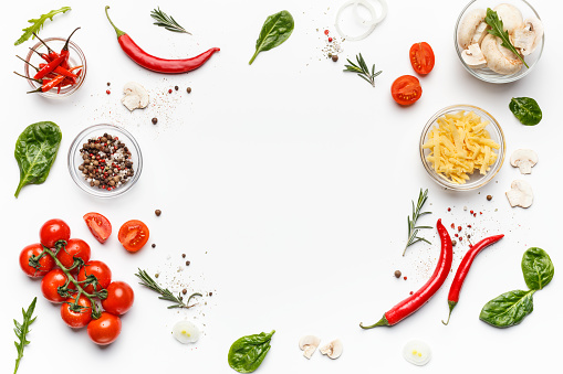 Colorful pizza ingredients. Tomatoes, cheese, chilli peppers and basil leaves on white background, top view, free space