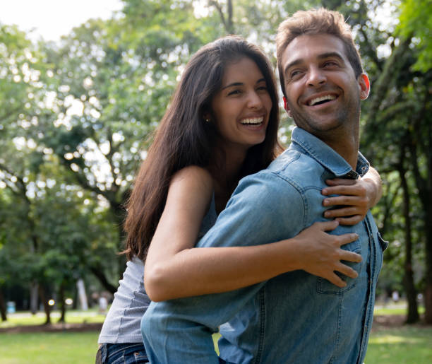 istock Happy couple having fun playing at the park 1136818002