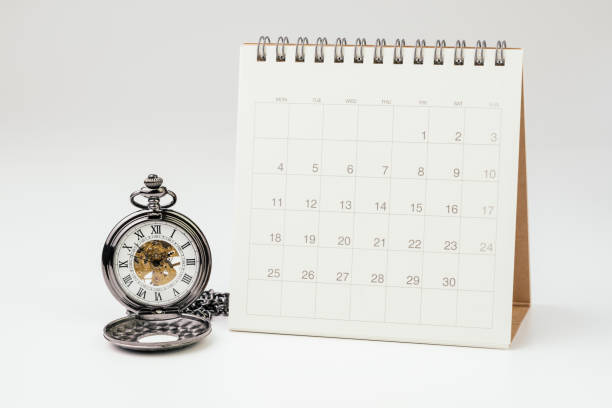 istock Vintage pocket watch with white clean desktop calendar on white background using as time passing, time management, year change or deadline concept 1136819387
