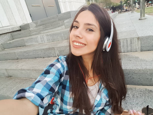 istock Urban girl making selfies downtown 1136819858