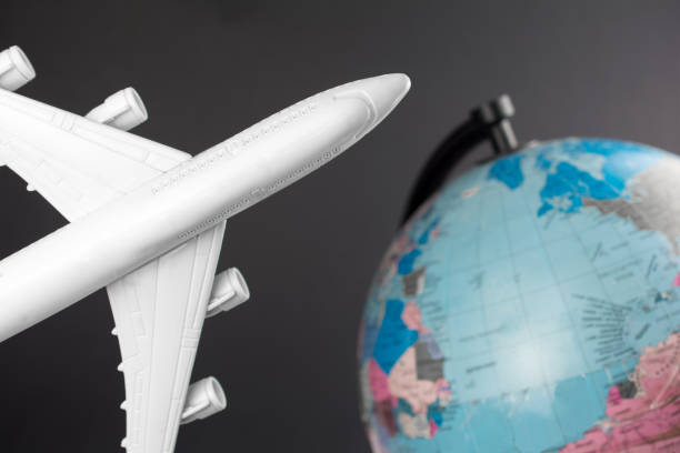 istock flight travel concepte. toy airplane end blurred globe 1136822052