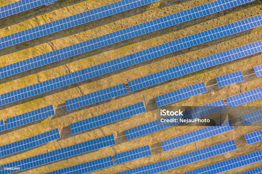 Drone view of solar panels Aerial drone view of solar panels at a solar energy farm. Vilnius county, Lithuania Above Stock Photo