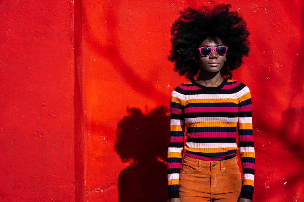 African woman standing on red background