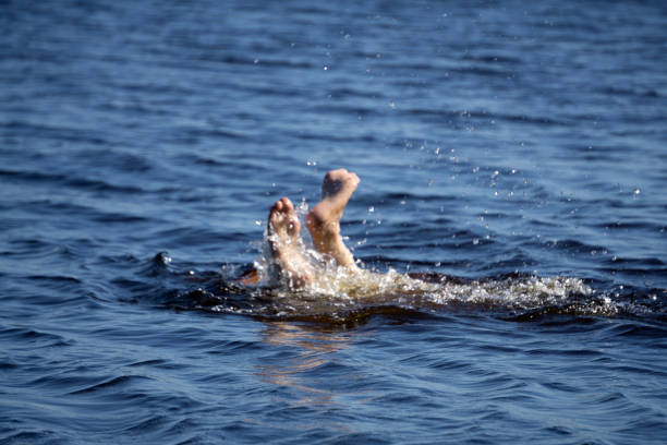 istock Old Man at sea drowning due to stroke and asking for help with palm upward . 1136824279
