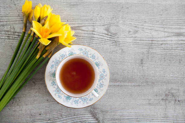 istock Cup of tea and Daffodils 1136827260