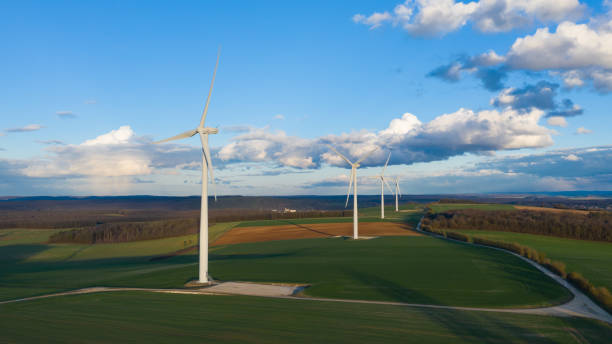 istock Four wind turbines in the middle of the fields at dusk 1136831634