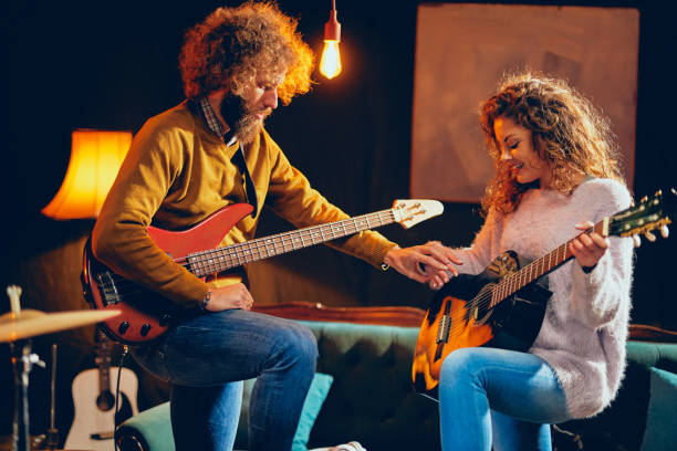 istock Musicians practice on guitars in home studio. 1136834470