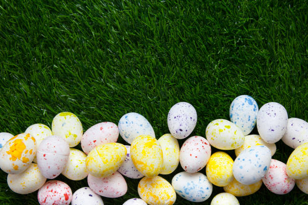 istock Pile of decorated eggs on grass background 1136834560