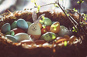 Easter decoration with crafted Easter bunny in the sunny nest