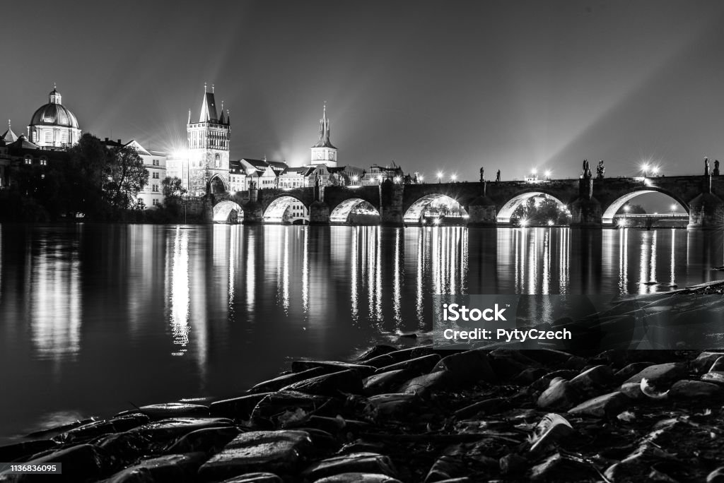 Vltava River and Charles Bridge with Old Town Bridge Tower by night, Prague, Czechia. UNESCO World Heritage Site Vltava River and Charles Bridge with Old Town Bridge Tower by night, Prague, Czechia. UNESCO World Heritage Site. Black and white image. Architecture Stock Photo