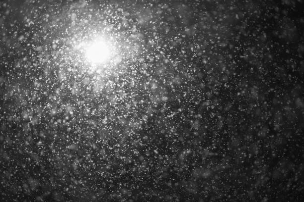 istock A street lamp illuminates large snow flakes in the evening. Unexpected spring snowfall 1136836649