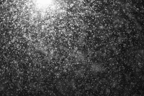 istock A street lamp illuminates large snow flakes in the evening. Unexpected spring snowfall 1136836667