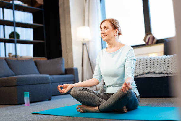 Tranquil good-looking woman meditating with closed eyes
