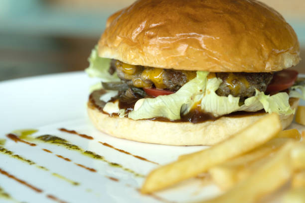 istock Beef burger and french fries appetizing on the white disc. 1136840083