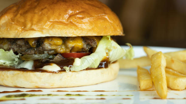 istock Beef burger and french fries appetizing on the white disc. 1136840089