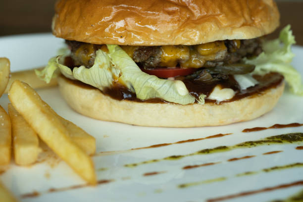 istock Beef burger and french fries appetizing on the white disc. 1136840119