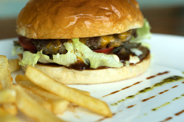 istock Beef burger and french fries appetizing on the white disc. 1136840122
